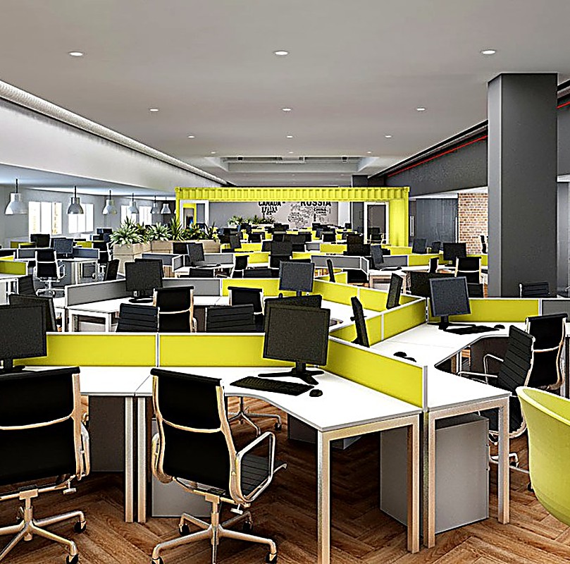 Modern open-plan office workstation area with desks and ergonomic chairs